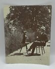 Old Photograph: Performing Dog with Smoker s Pipe in Mouth, Man Watching.